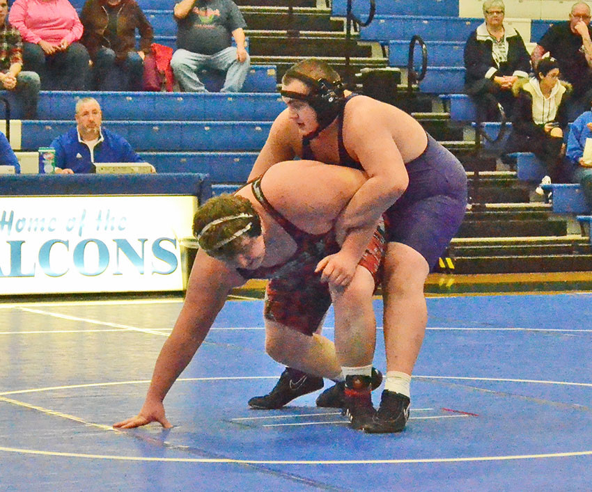 Ada’s Adam Bailey attempts to put a hold on a Bucyrus opponent in a 285-pound bout. 