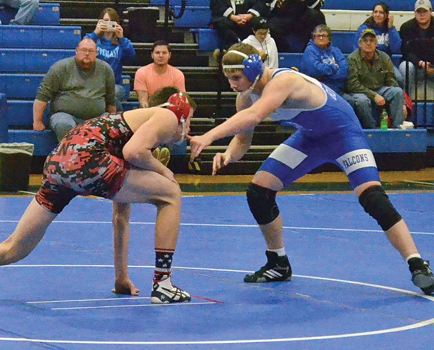 Riverdale’s Blake Creedley and a Bucyrus opponent size each other up early in their 145-pound bout during the Falcons home tri-match with Ada and the Redmen on Wednesday night.