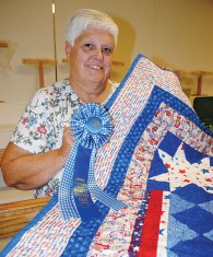 With the names of the states and diversity of people, the quilt entered by Rebecca Buxton of Kenton brought home a grand championship honor in the holiday division of the arts and craft show.