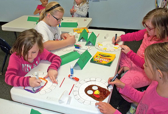 Kids work on turkey masks