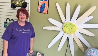 Lenora Prichard with some of the artwork at KudoStudio